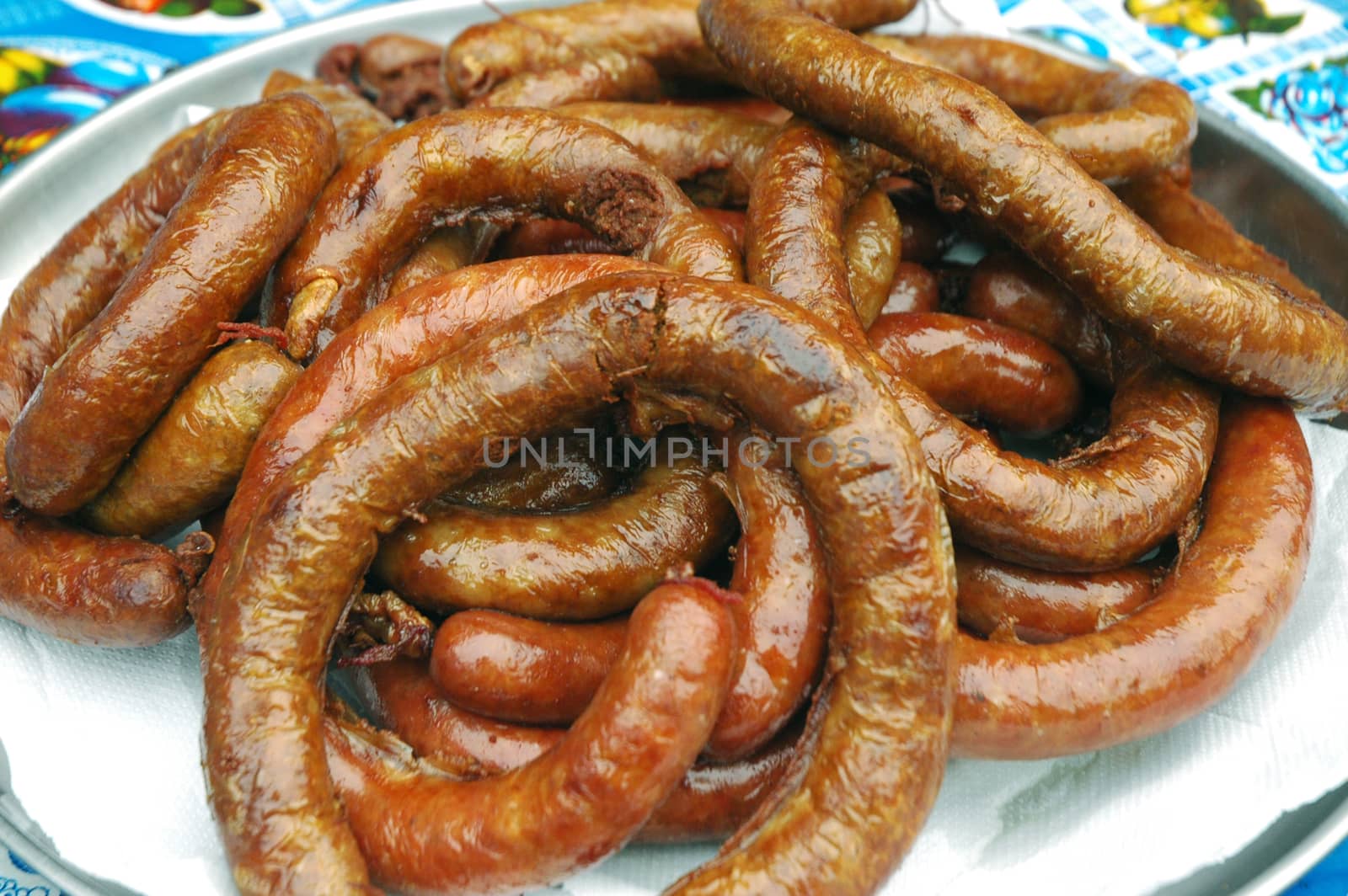 sausage is a cylindrical meat product usually made from ground meat, often pork, beef or veal, along with salt, spices and other flavourings and breadcrumbs, with a skin around it. Typically, a sausage is formed in a casing traditionally made from intestine, but sometimes from synthetic materials
