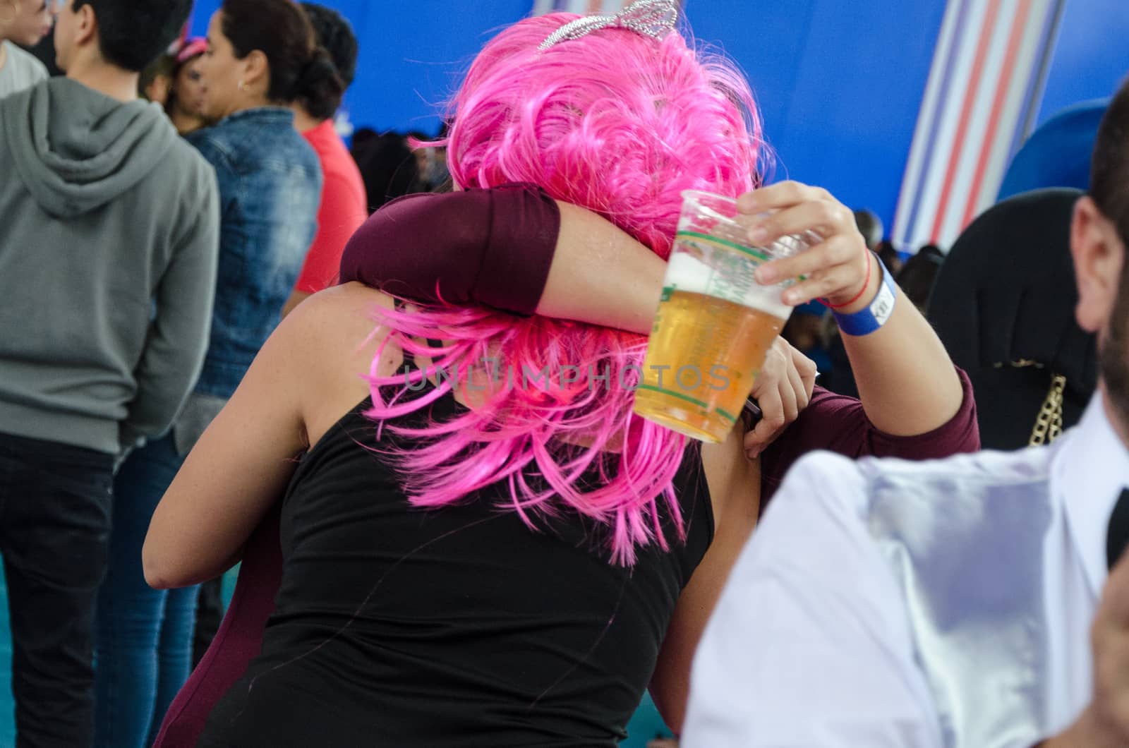 Women hugging with a beer in their hand