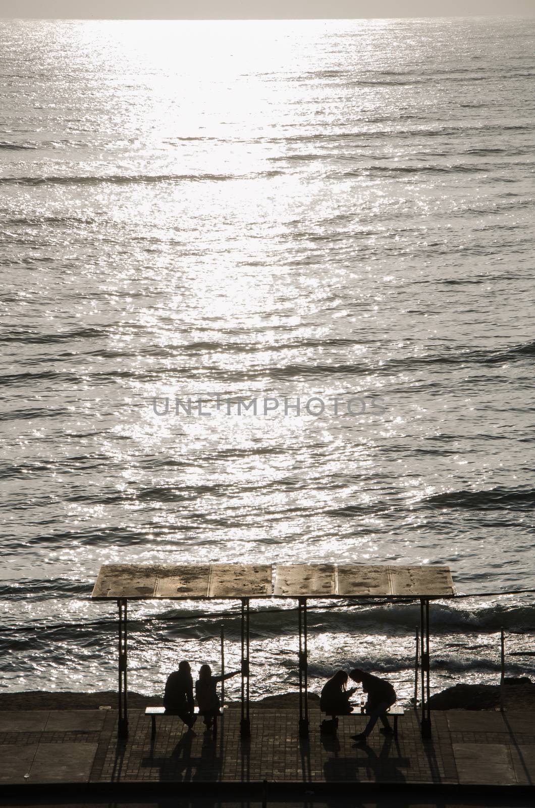 Seated people on the coast of Lima - Peru