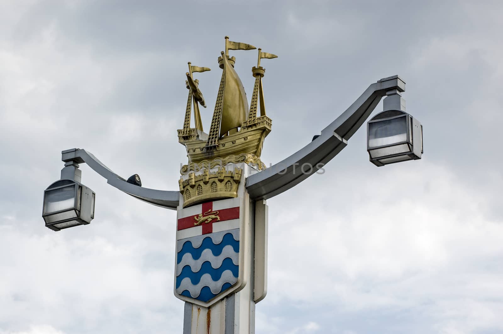One of the four art deco style lamp posts at the entrances to Chelsea Bridge, London. A golden galleon ship sits on top of the old London County Council coat of arms. Public display since 1937.