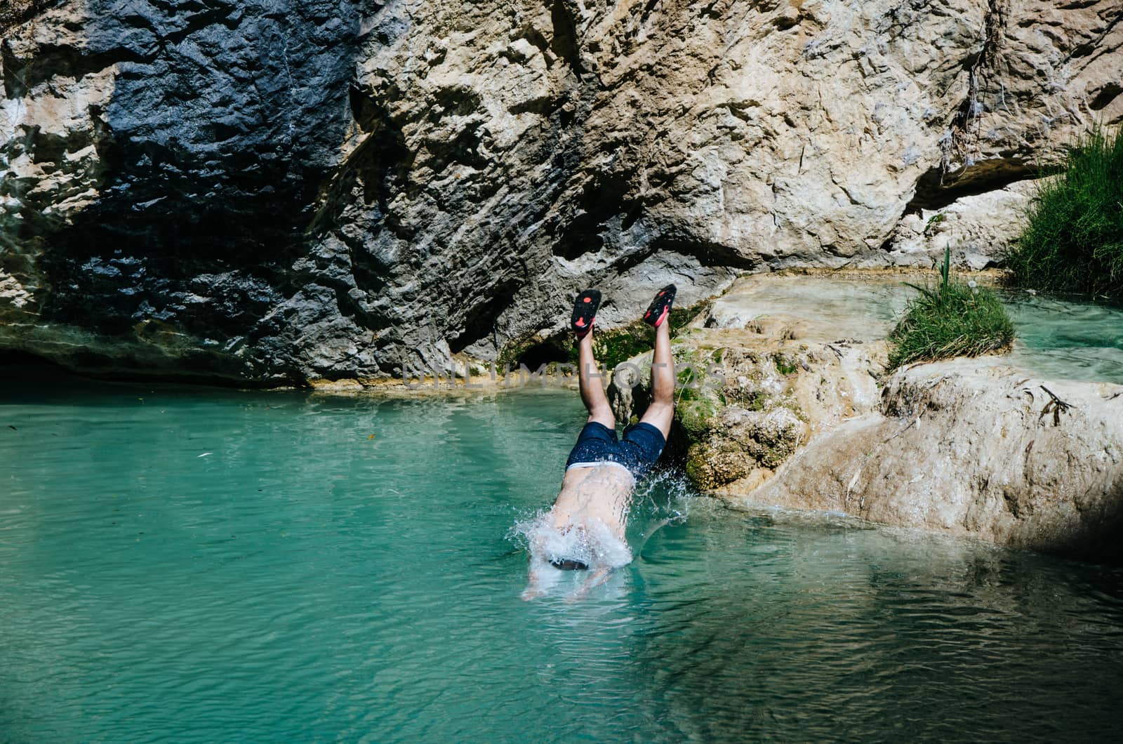 Man doing a dive towards the lake