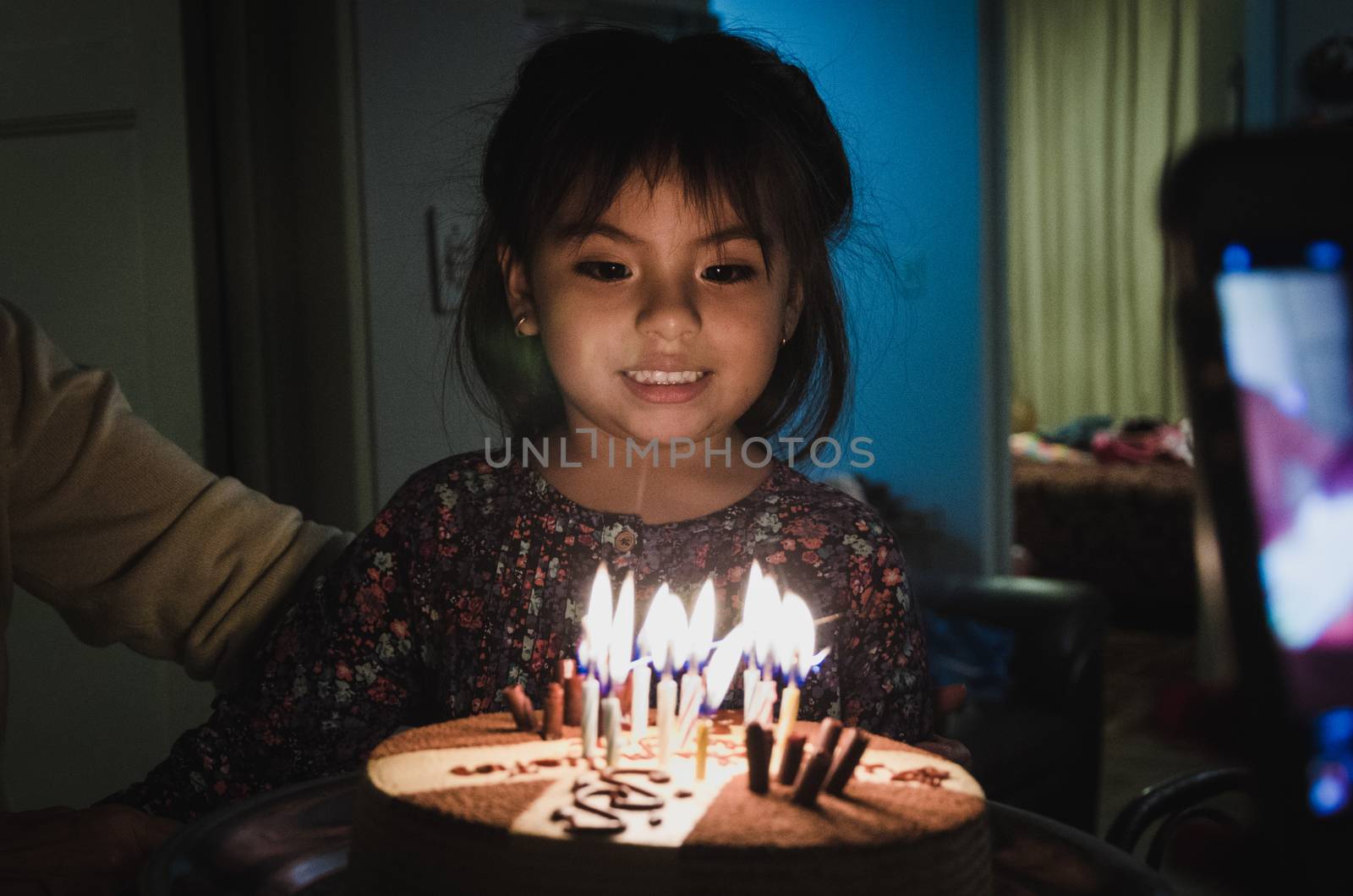 Cake with candles in front of an excited girl