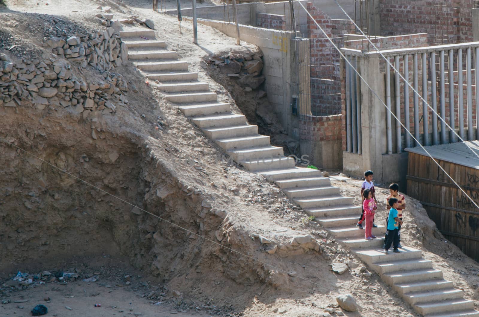 Children coming down the hill by the stairs