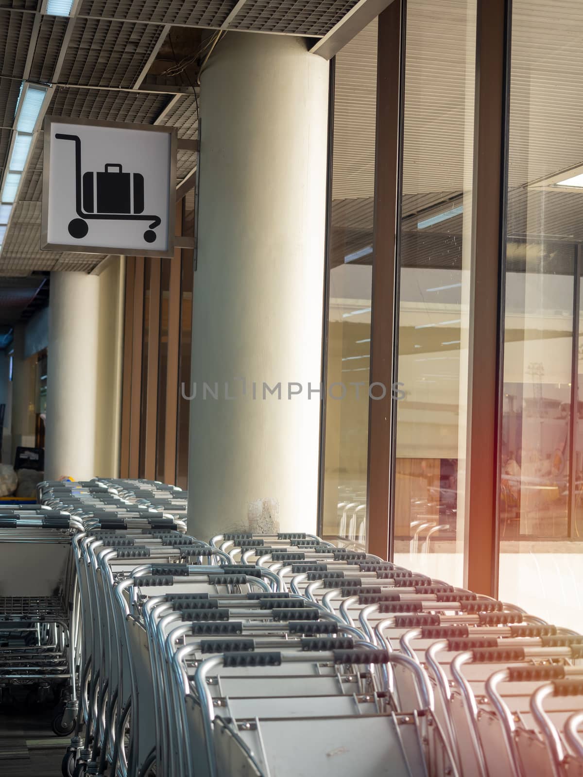 Airport luggage cart in airport near the glass window vertical style.