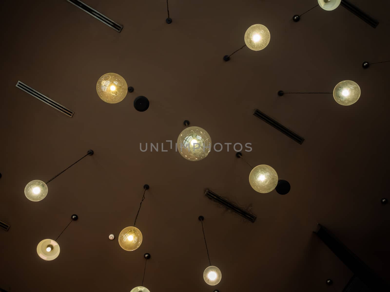 Ceiling light bulbs retro style hanging from ceiling in dark roo by tete_escape