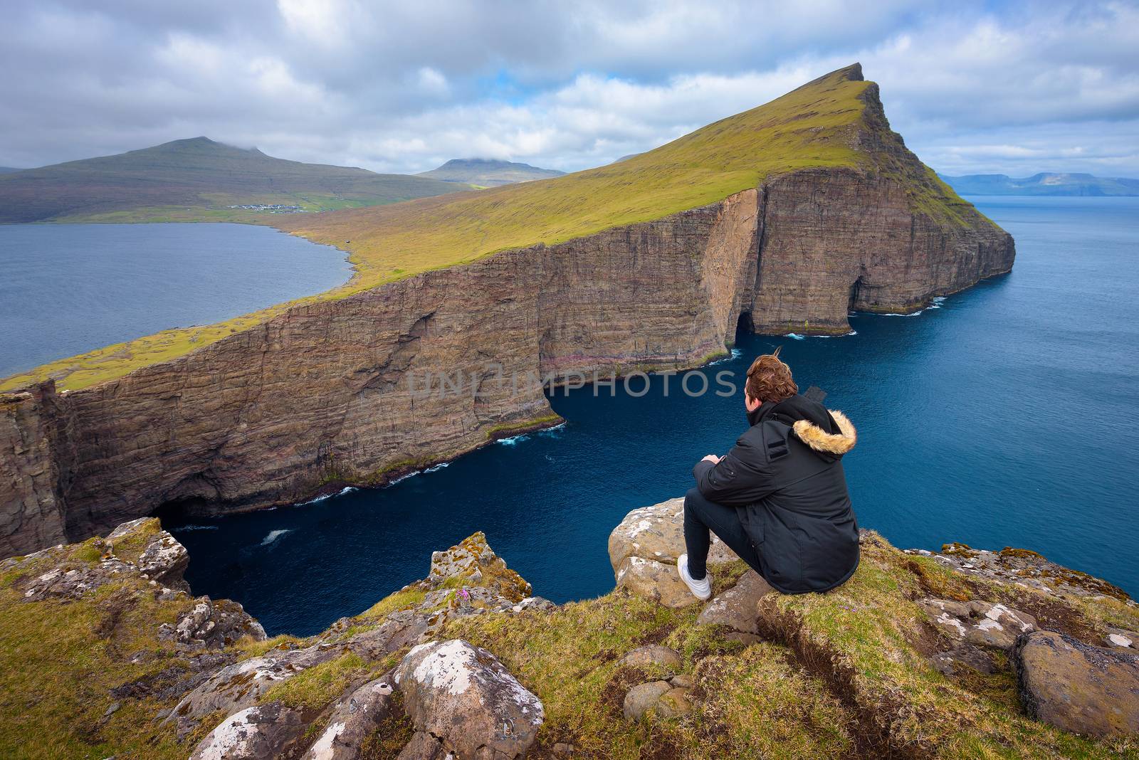 Hiker looking at the lake Sorvagsvatn on Faroe Islands by nickfox