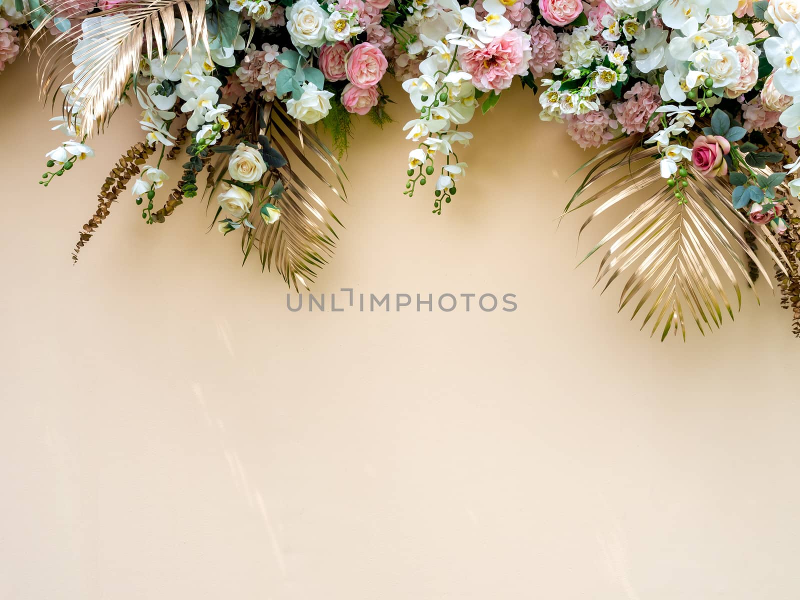 Celebration decoration background with gold tropical palm leaves with white and pink roses flower bouquet with copy space.