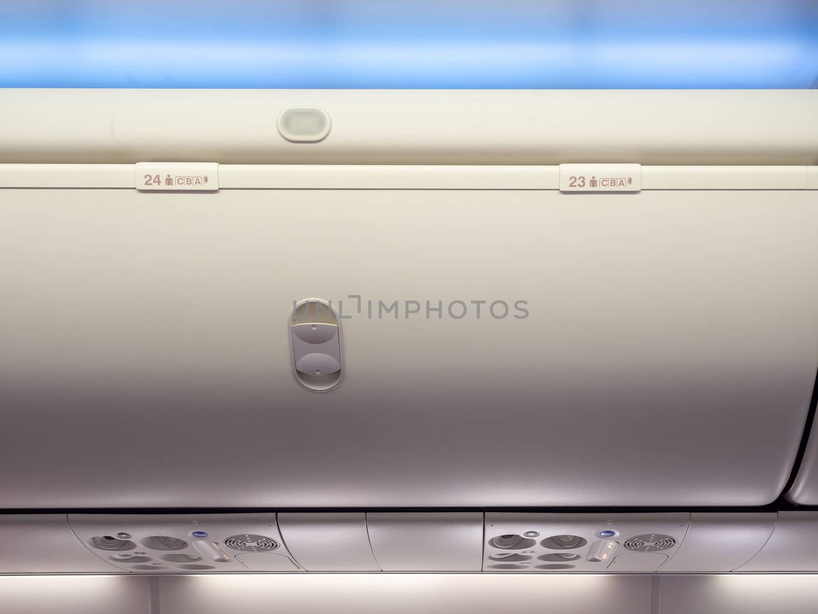 Hand-luggage compartment number 23 and 24 in cabin economy class on the low cost commercial airplane.
