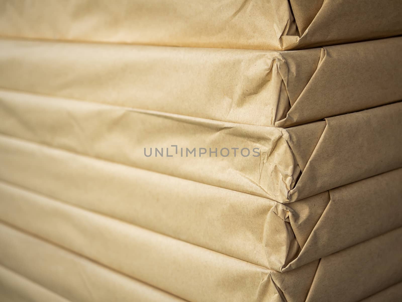 Stack of brown paper packaging. Close-up side of corner of wrapping packaging.