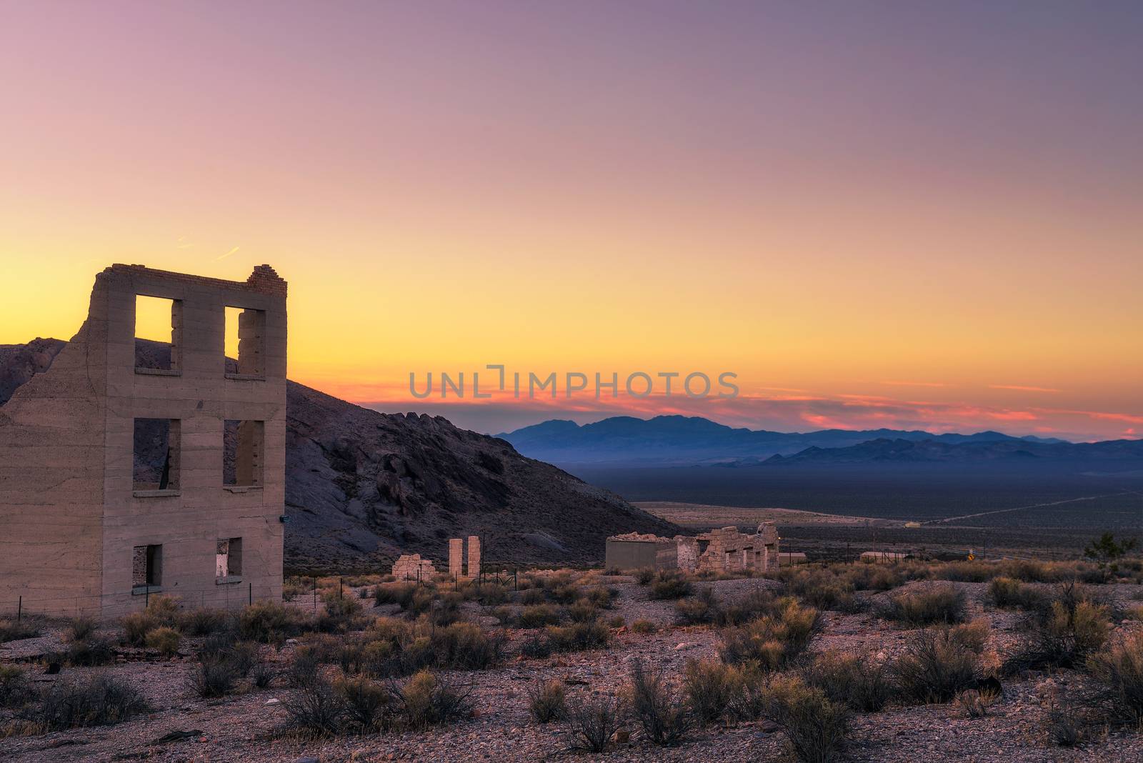 Sunrise above abandoned building in the town of Rhyolite, Nevada. This ghost town is located in Nye County among Bullfrog Hills near Death Valley.