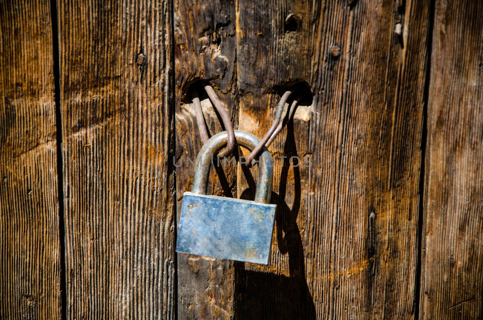 Occident padlock on an old deteriorated door