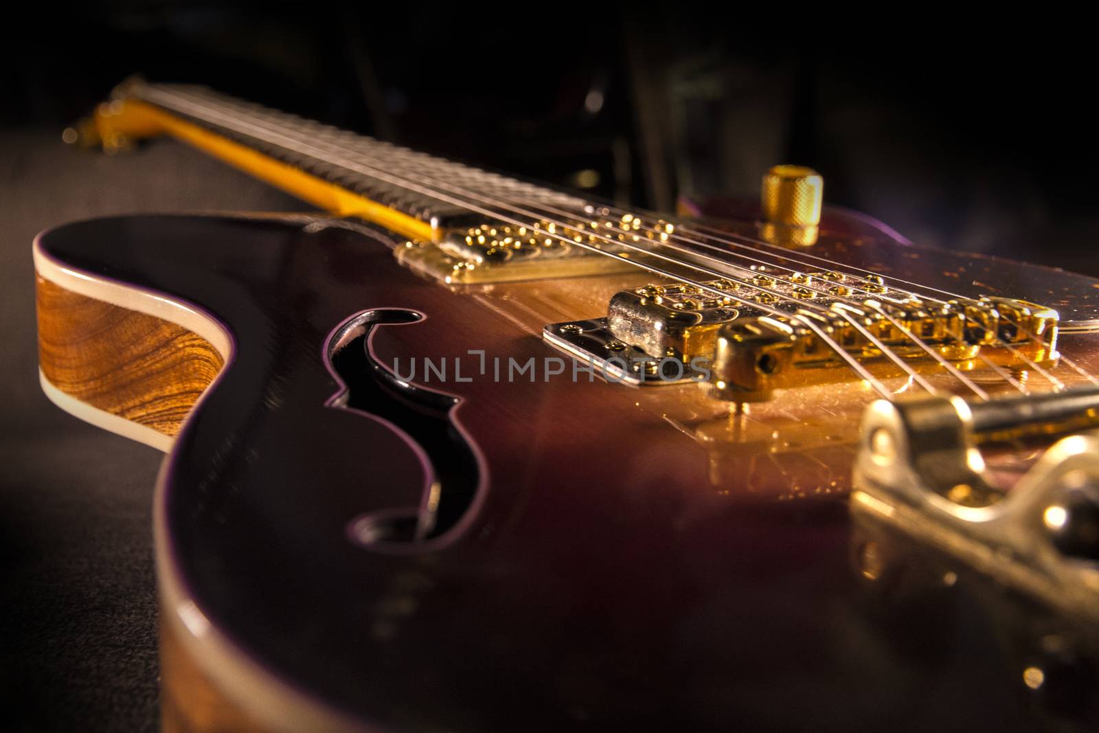 Closeup of sunburst electric guitar with brass mechanics and bri by robbyfontanesi