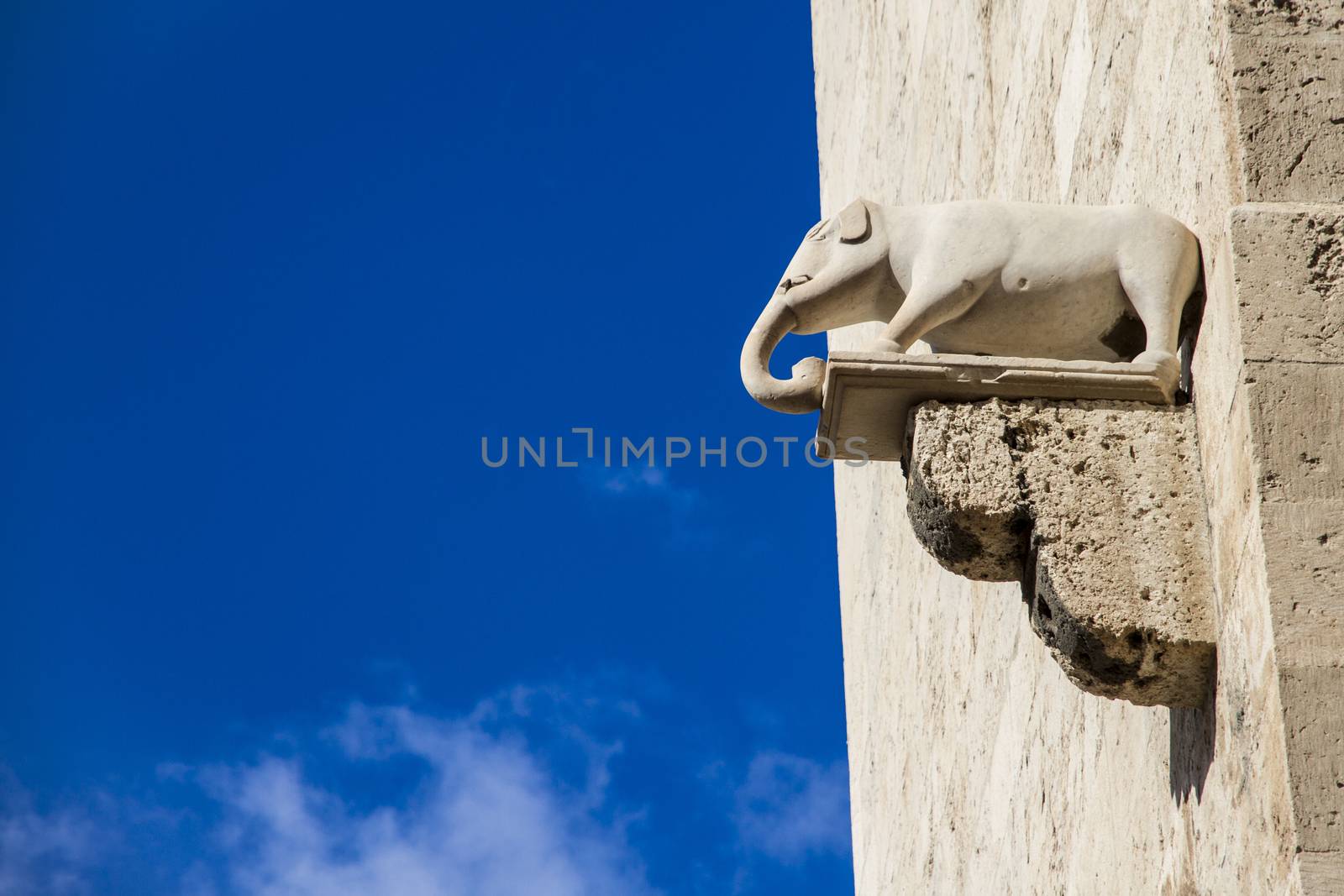 Stone elephant sticking out from ancient limestone walls of a castle in Cagliari in Italy