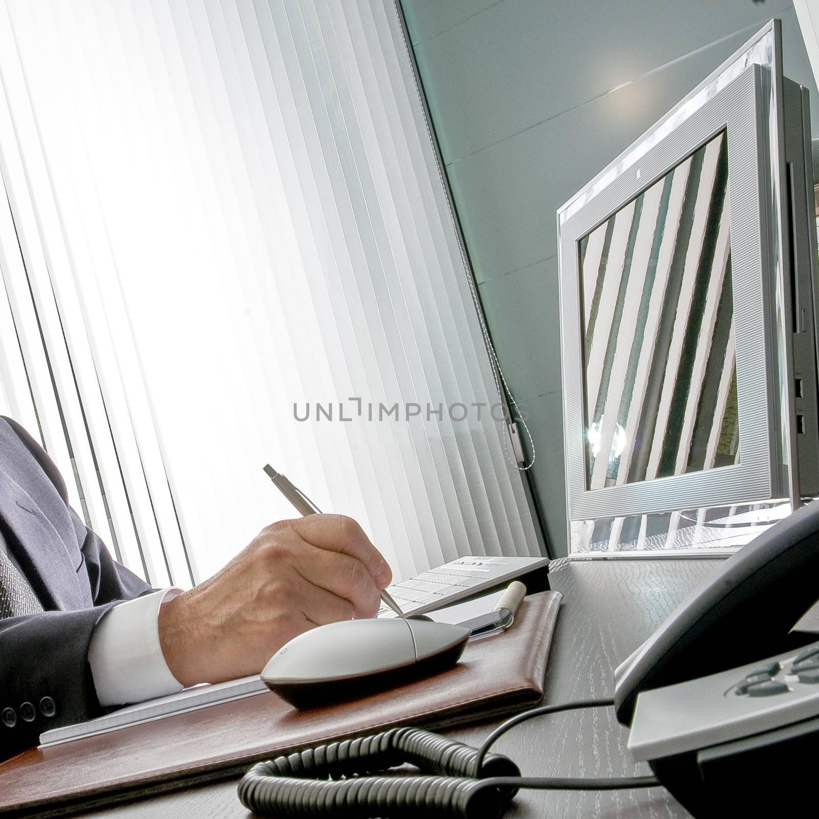 Manager at work. The expert hand of a businessman sitting at his by robbyfontanesi