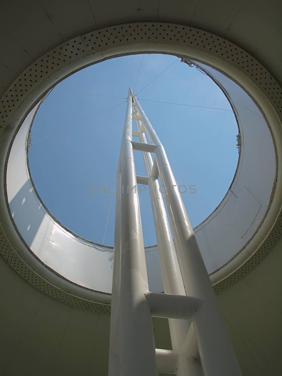 Modern architecture of a mast emerging out of a circular opening
