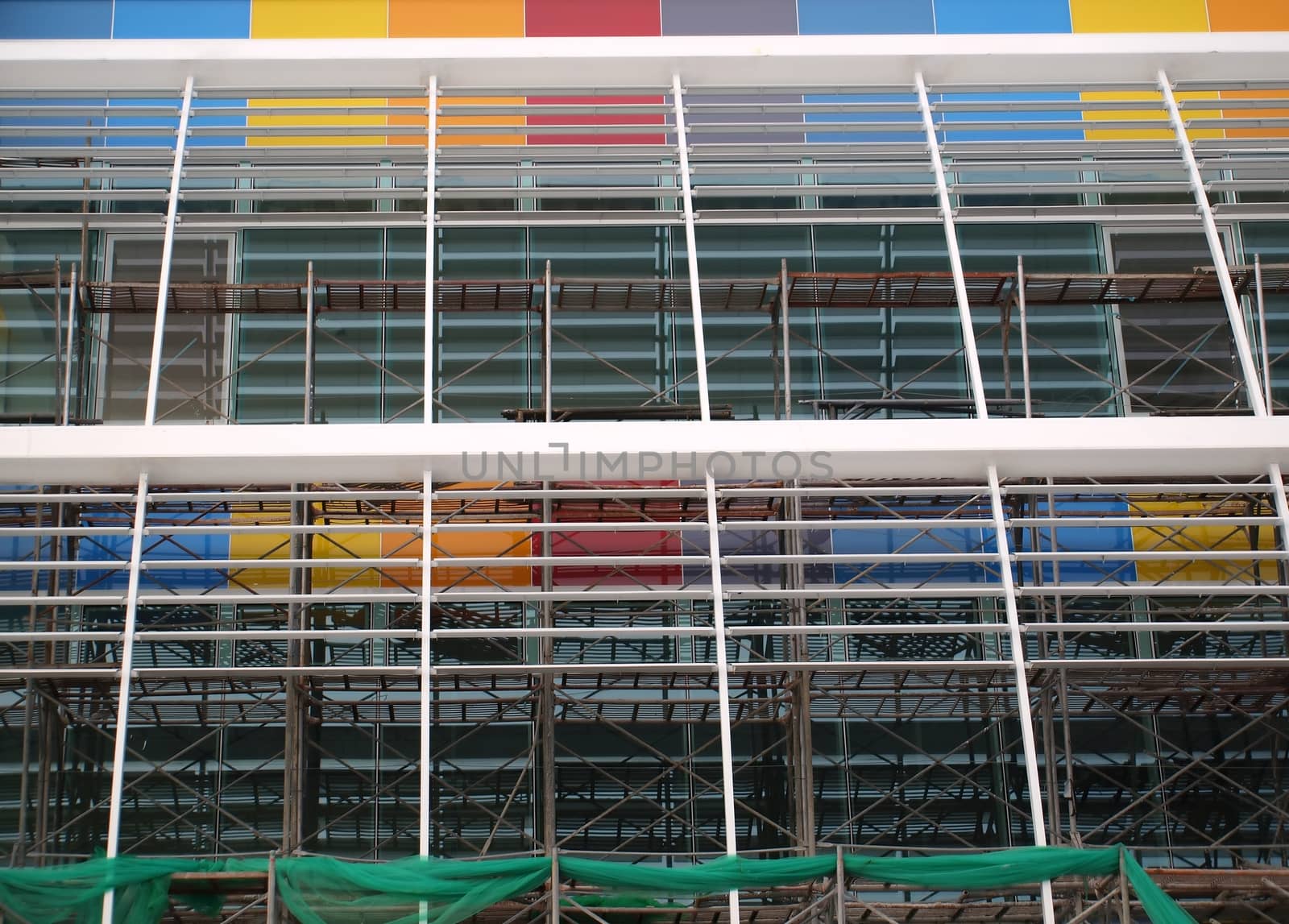 Modern structure with scaffolding and colorful panels
