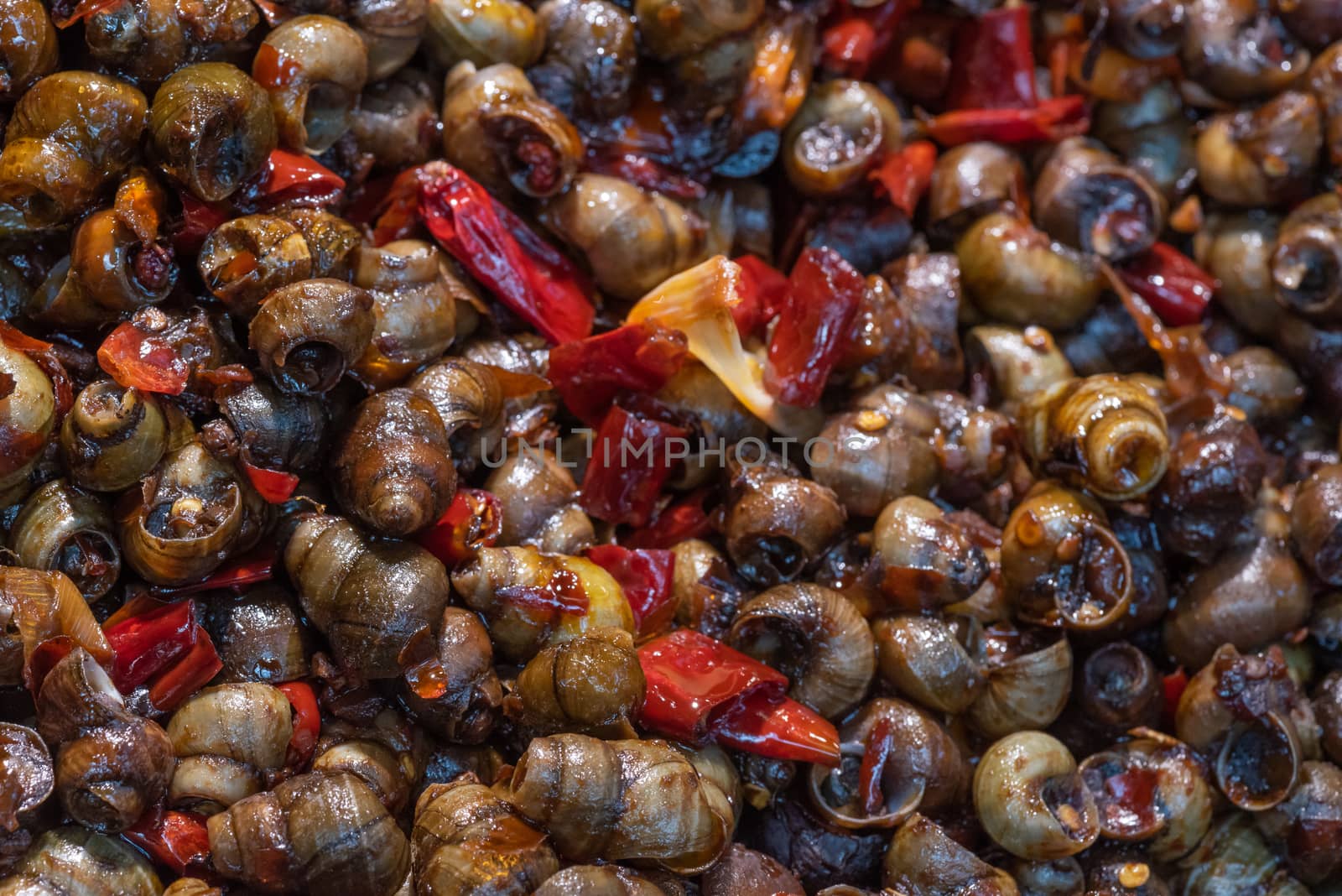field snail stir fried with chili sauce on a market in Chengdu, Sichuan province, China