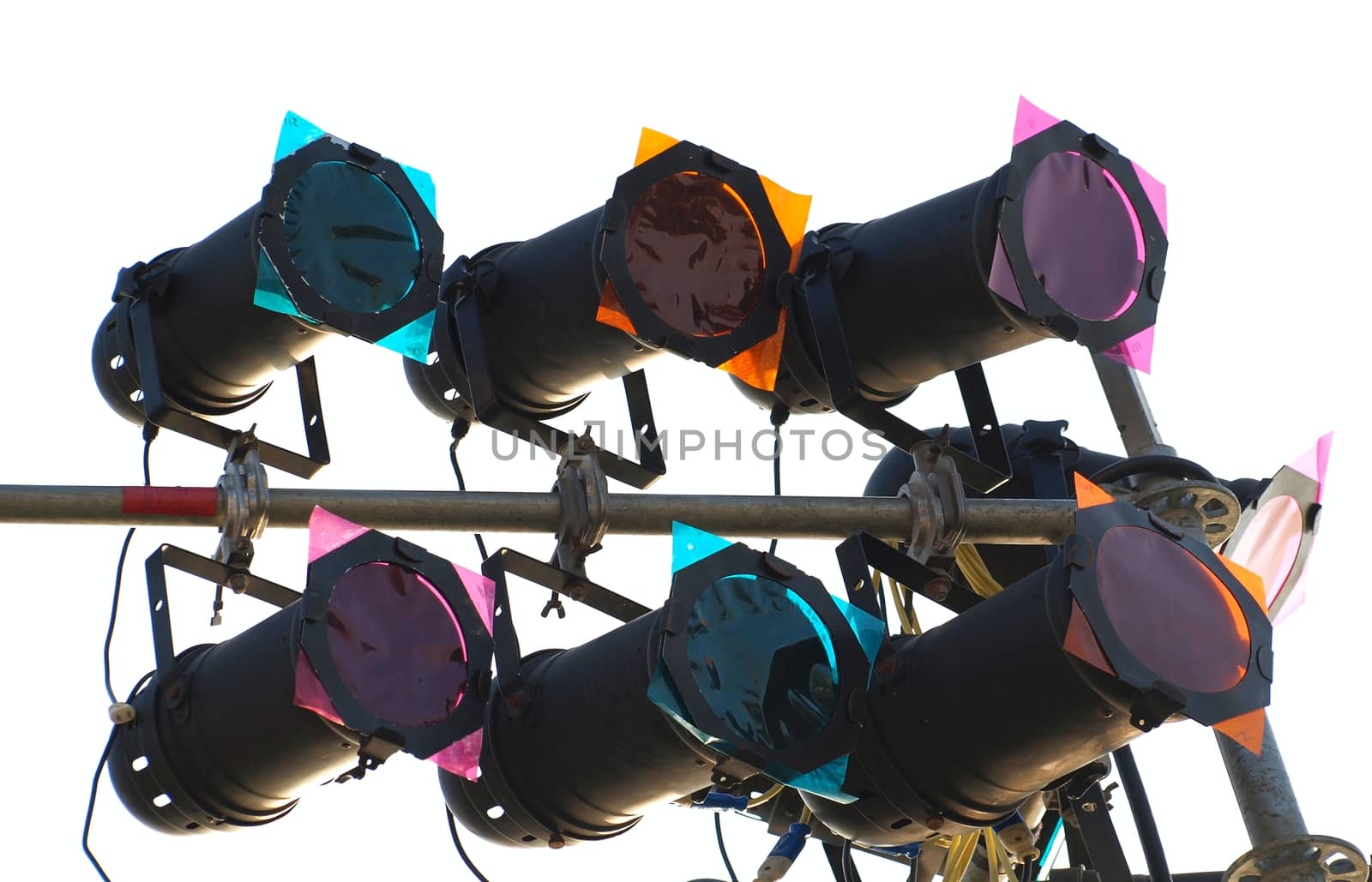 Multi-colored spotlights are mounted on metal poles
