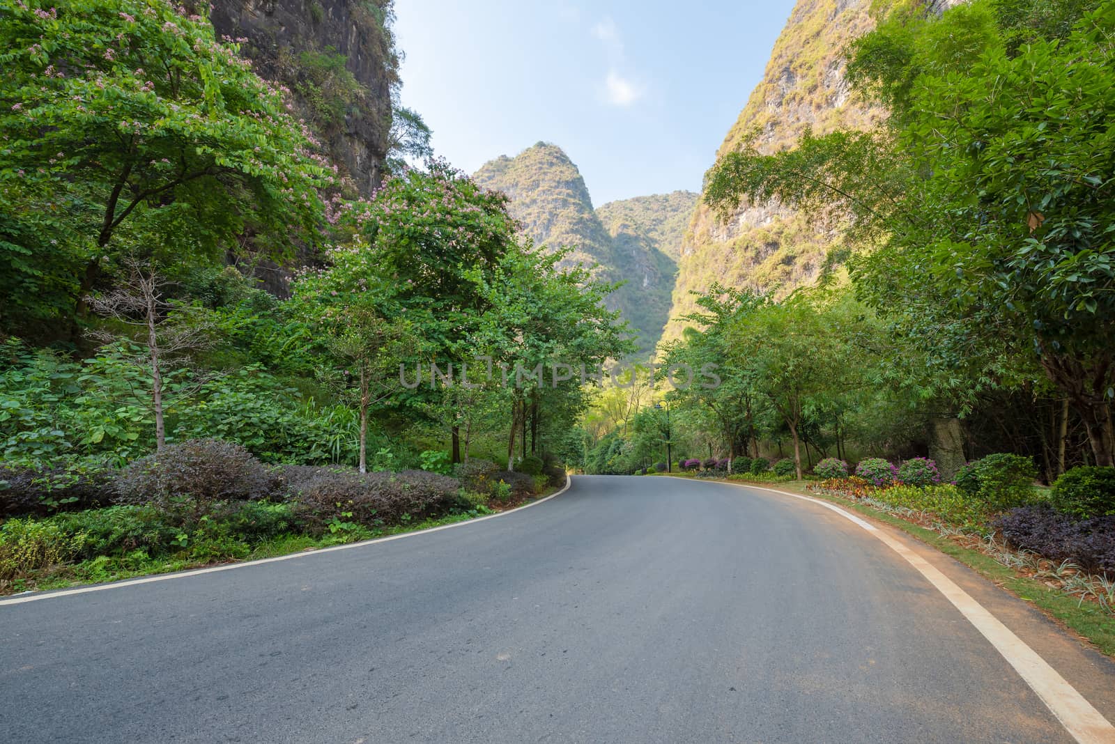 Empty road with karst hills in the background in Yangshuo, Guilin, Guangxi province, China