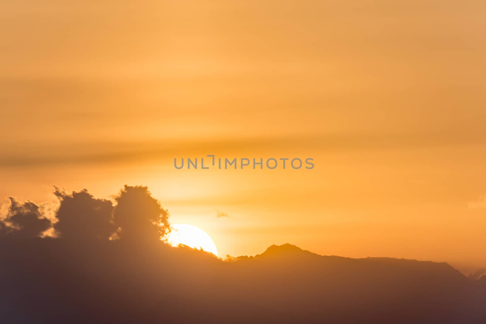 Beautiful sunset behind the clouds with copy space