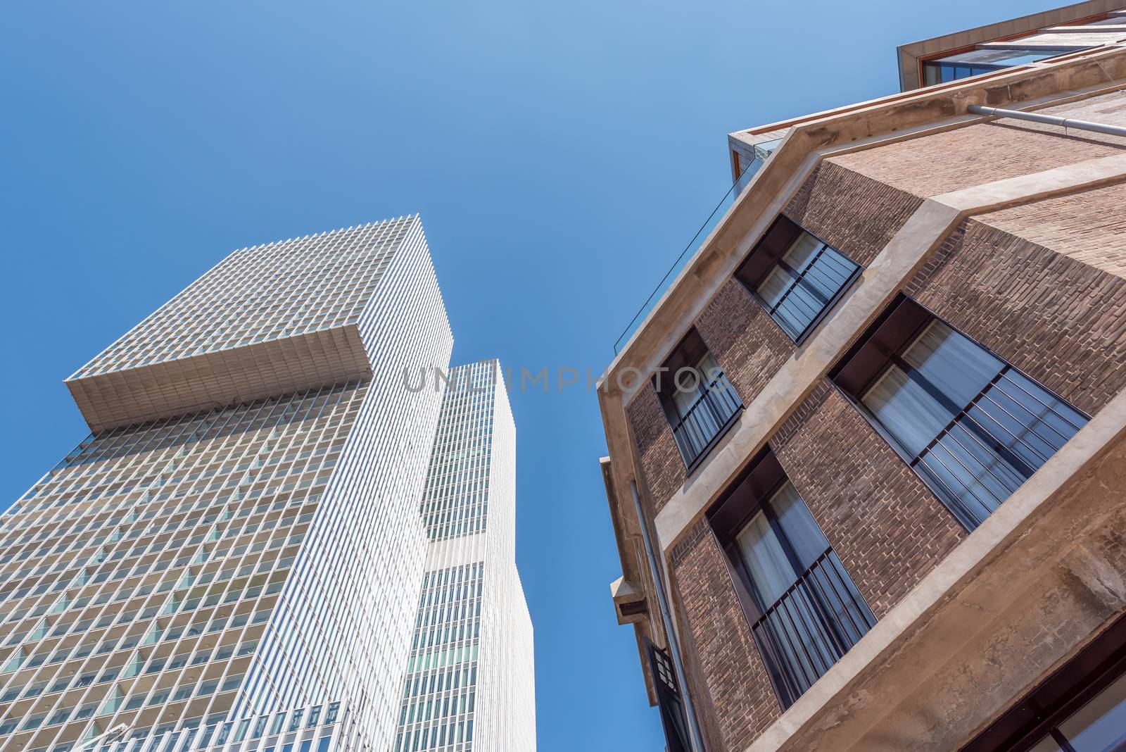 Ancient and modern buildings against blue sky in Rotterdam, Netherlands