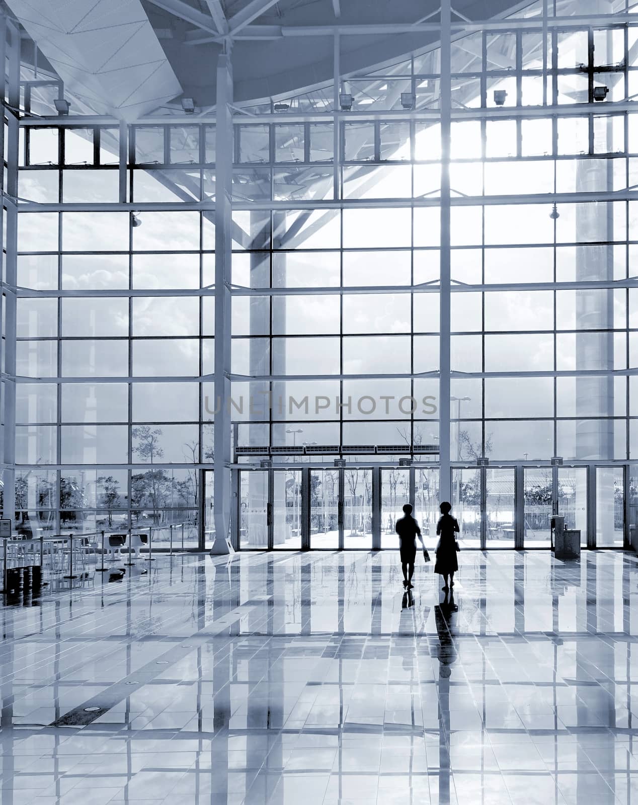 A modern corporate building detail with highly polished floors and glass and steel facade
