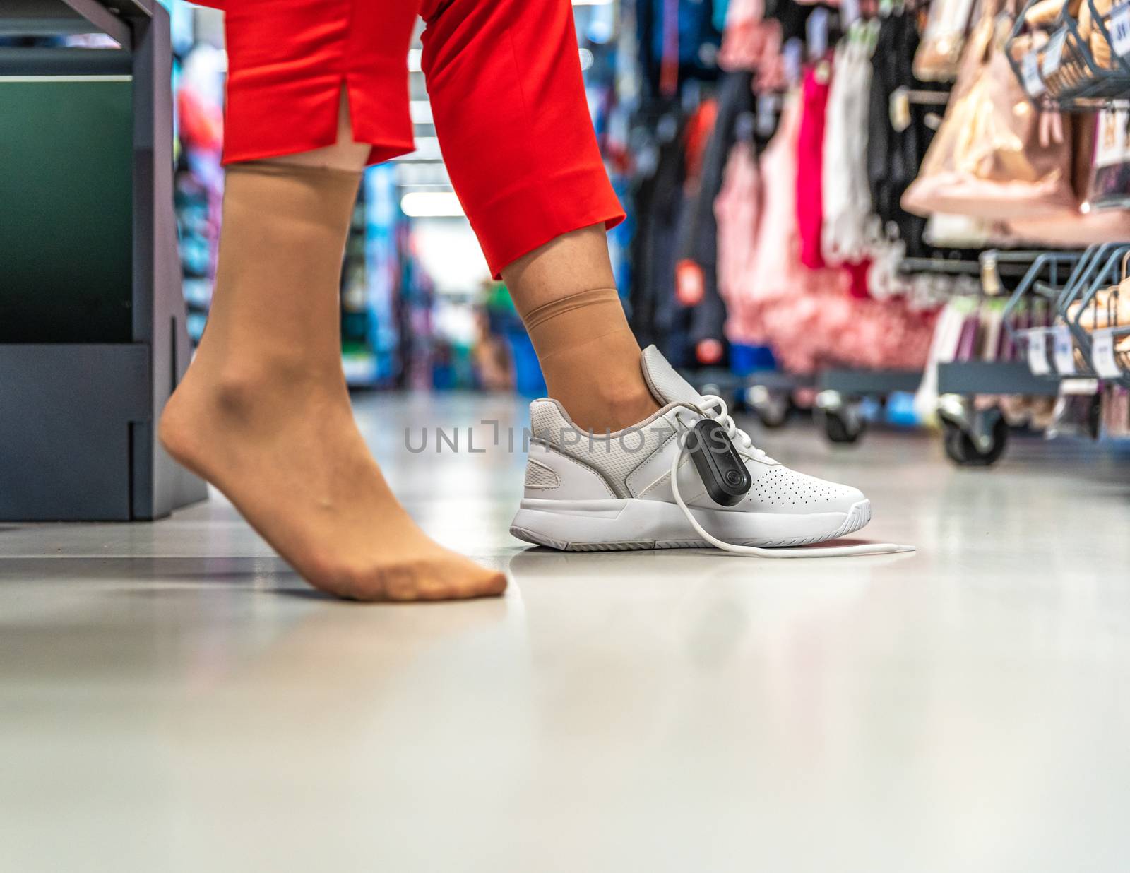 woman chooses and tries sports shoes in the store.