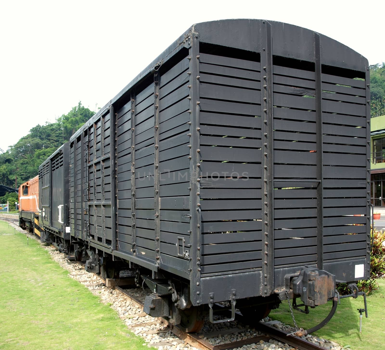 A vintage railroad car on a narrow track