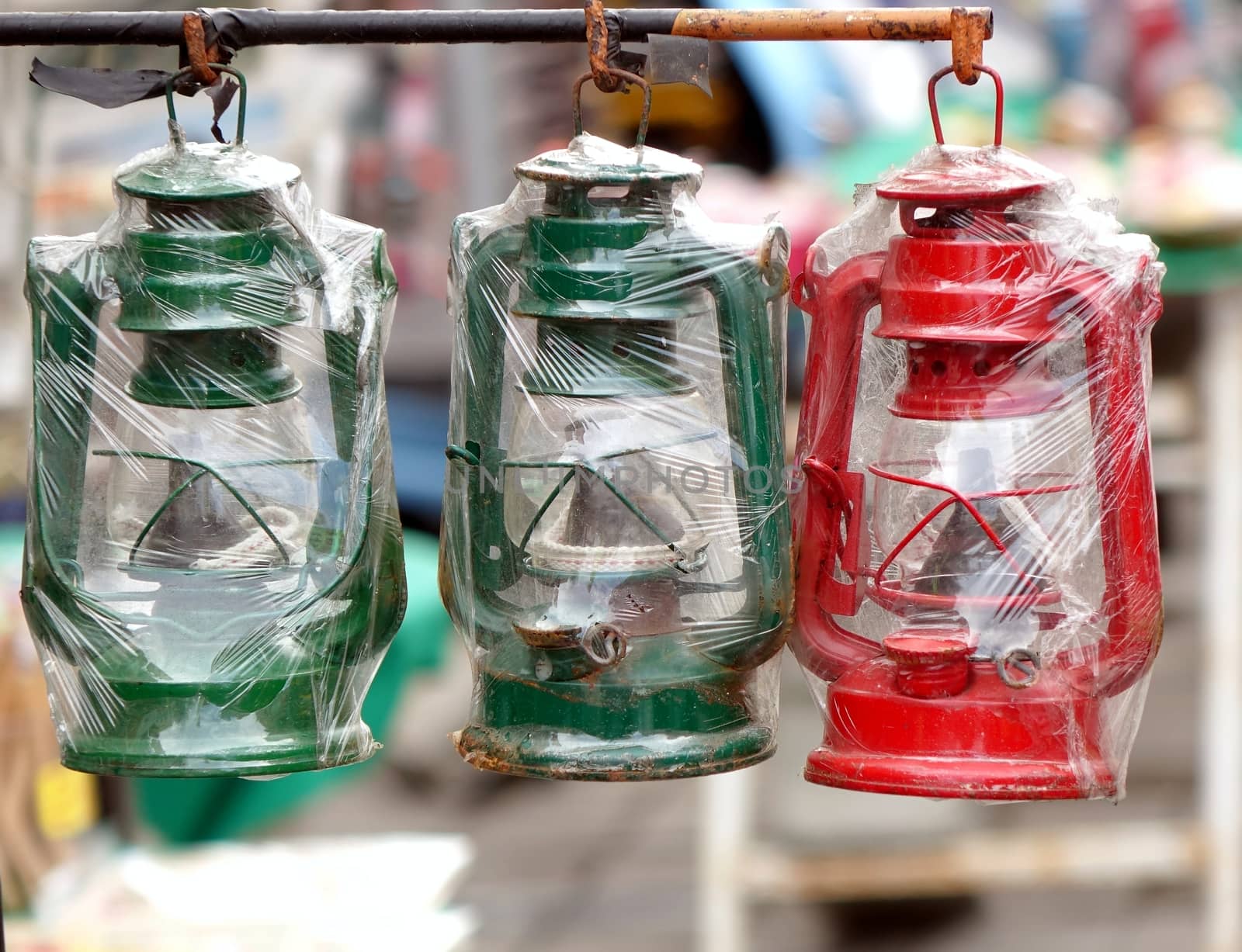 Old style cold blast kerosene lamps in green and red
