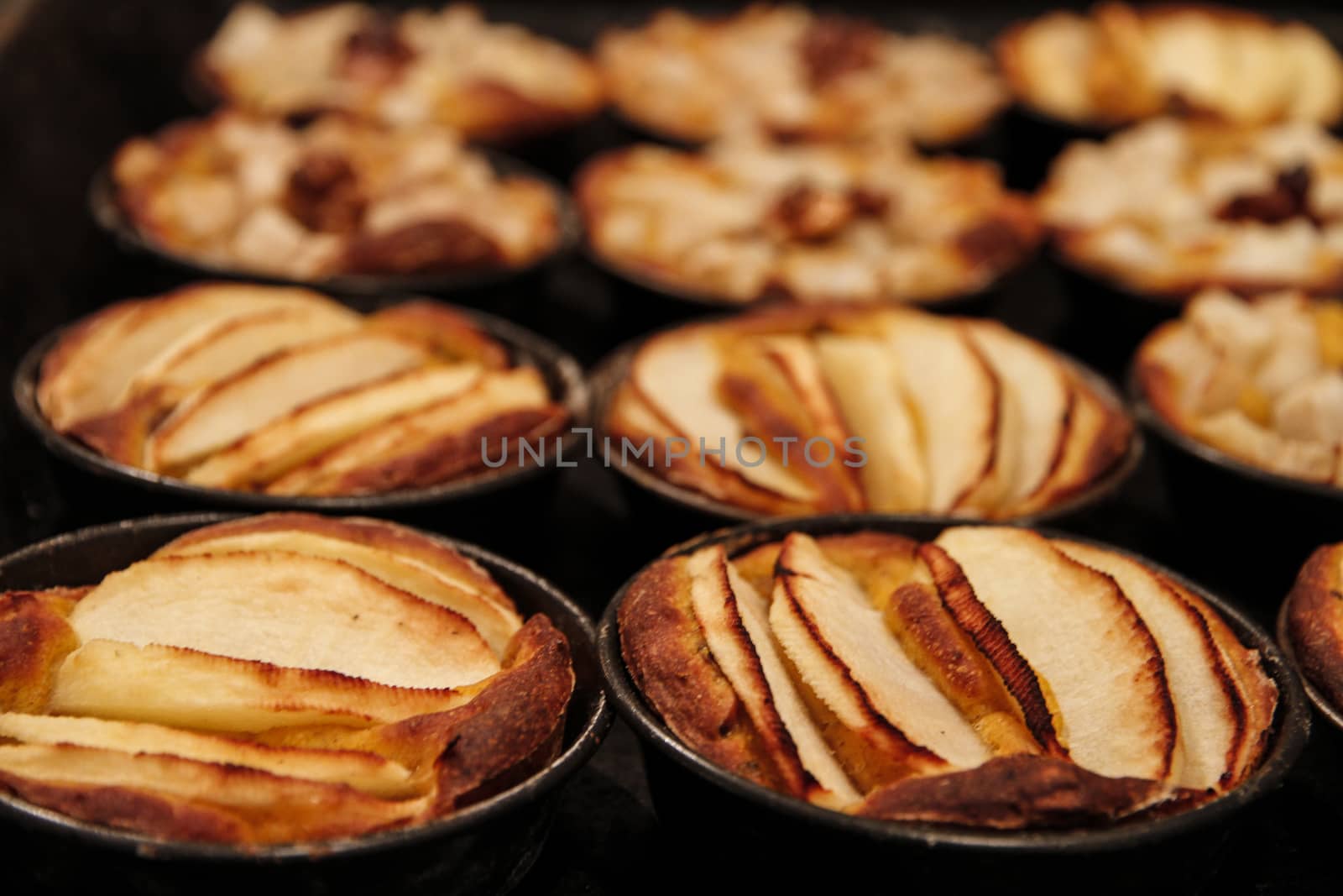 Small homemade apple pies freshly baked each in its mold