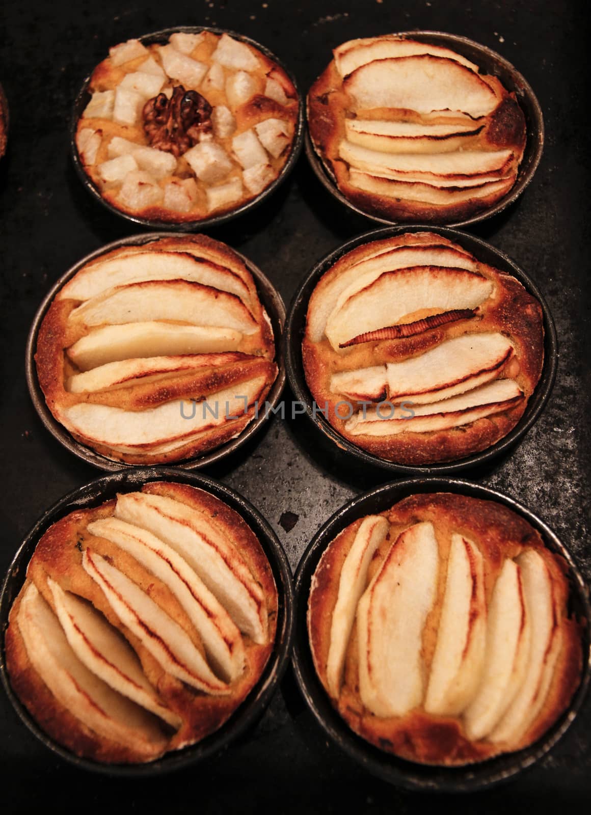 Small homemade apple pies freshly baked each in its mold