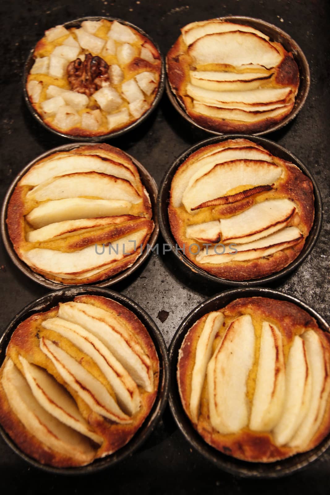 Small homemade apple pies freshly baked each in its mold