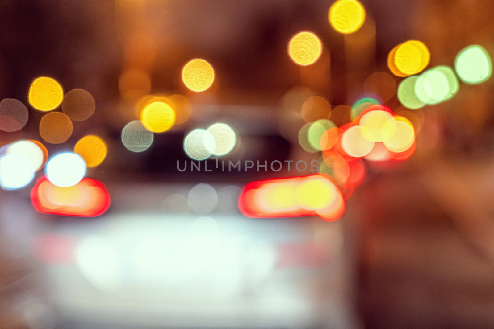 Blurred defocused colorful lights of traffic in the city, the night city with boken