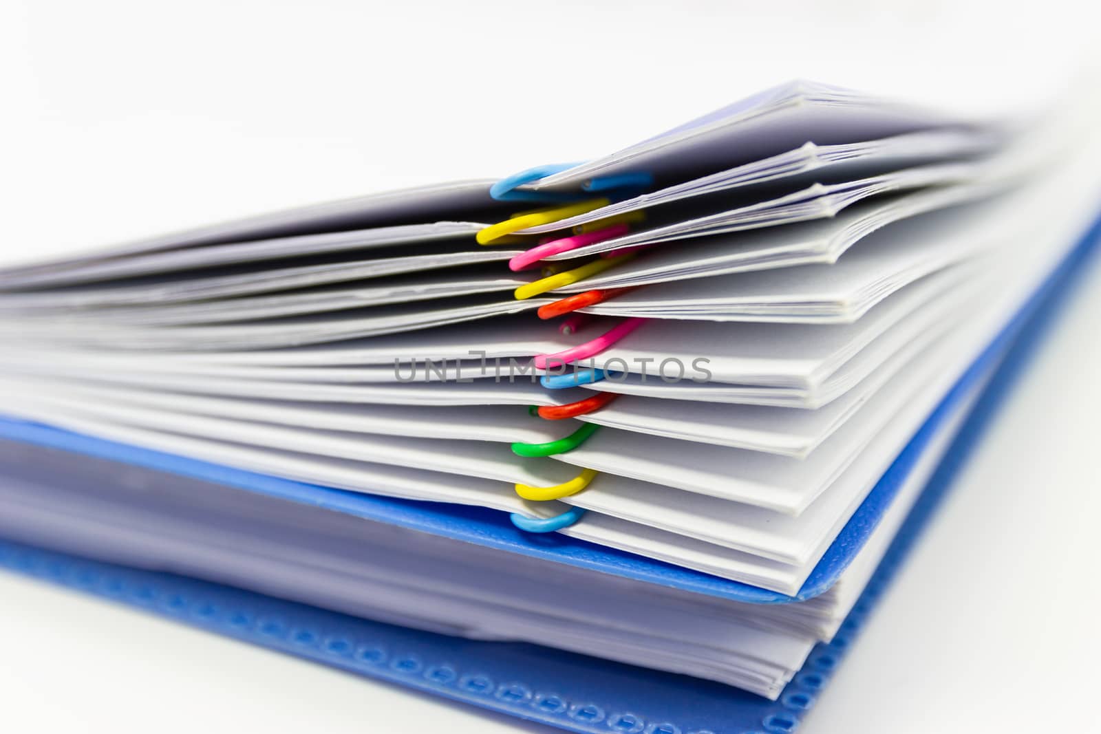 close up of Stack of papers files piles of unfinished documents achieves with paper clips 
