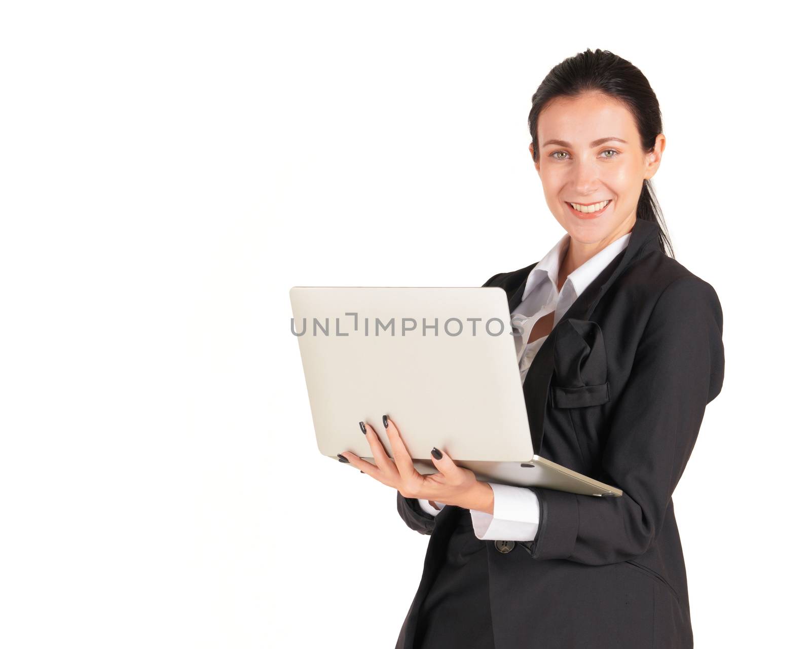 A business woman in a black suit with a smile and typing on a computer notebook. by chadchai_k