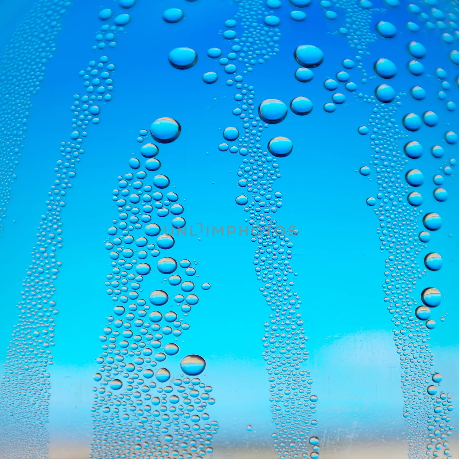 Abstract background. Drops of water on the crooked glass, shallow dof