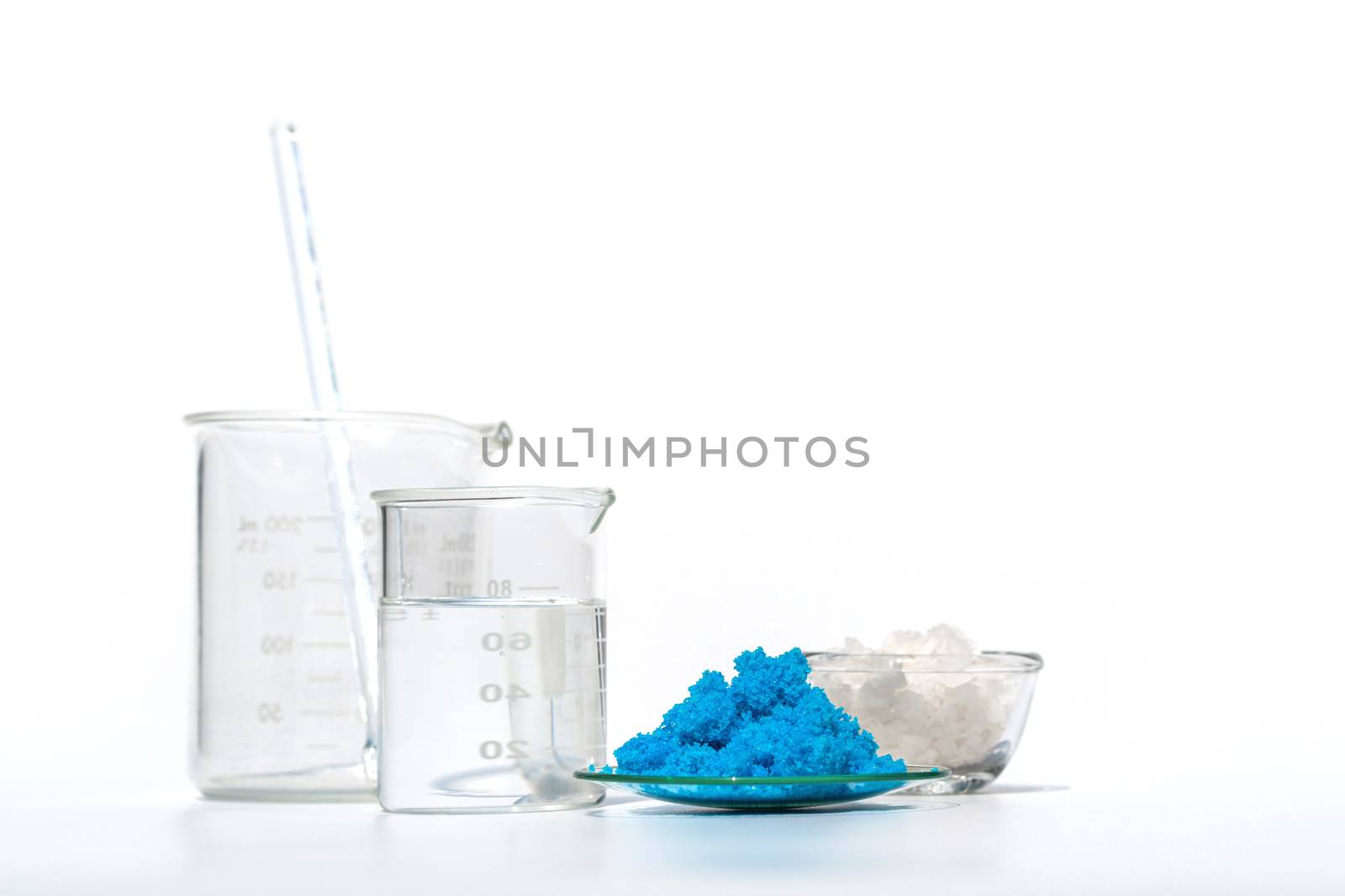 Close up inorganic chemical on white laboratory table. Copper(II) sulfate, Sea Salt, alcohol. Chemical ingredient for Cosmetics & Toiletries product.