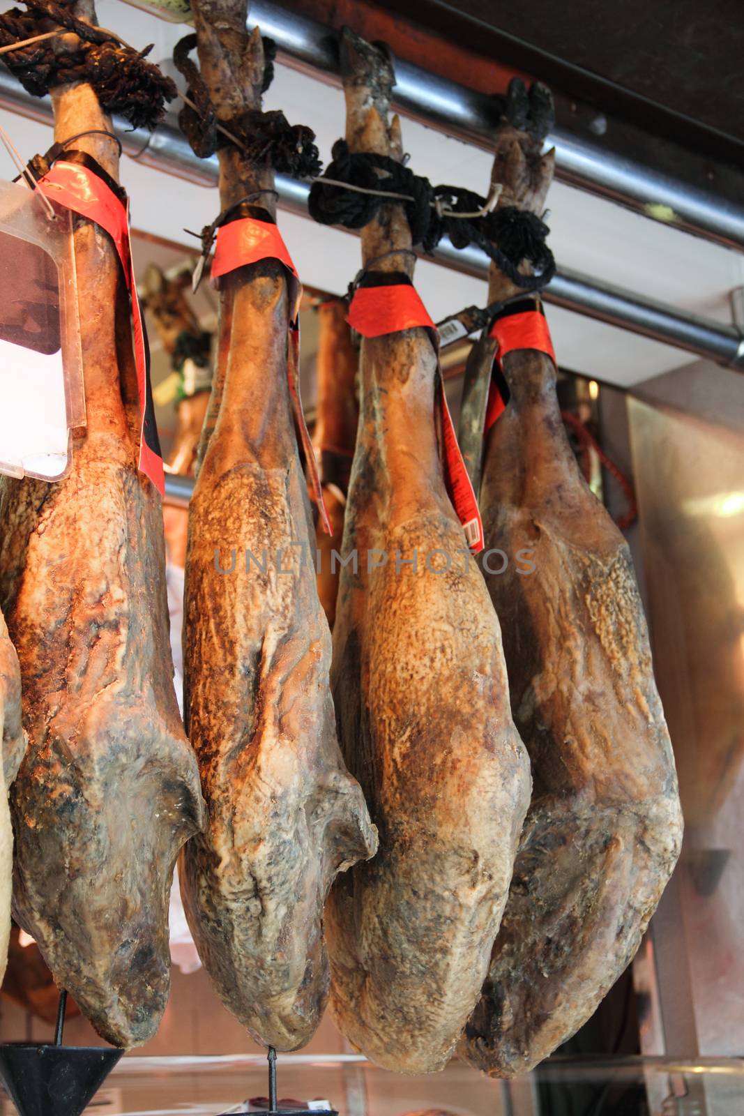 Jamon pork legs at market in Spain, traditional spanish ham close up. Hamon iberico