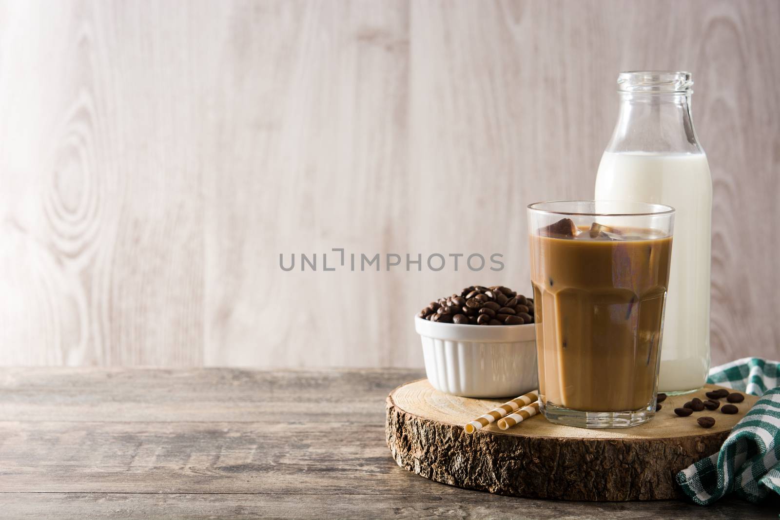 Iced coffee or caffe latte in tall glass by chandlervid85