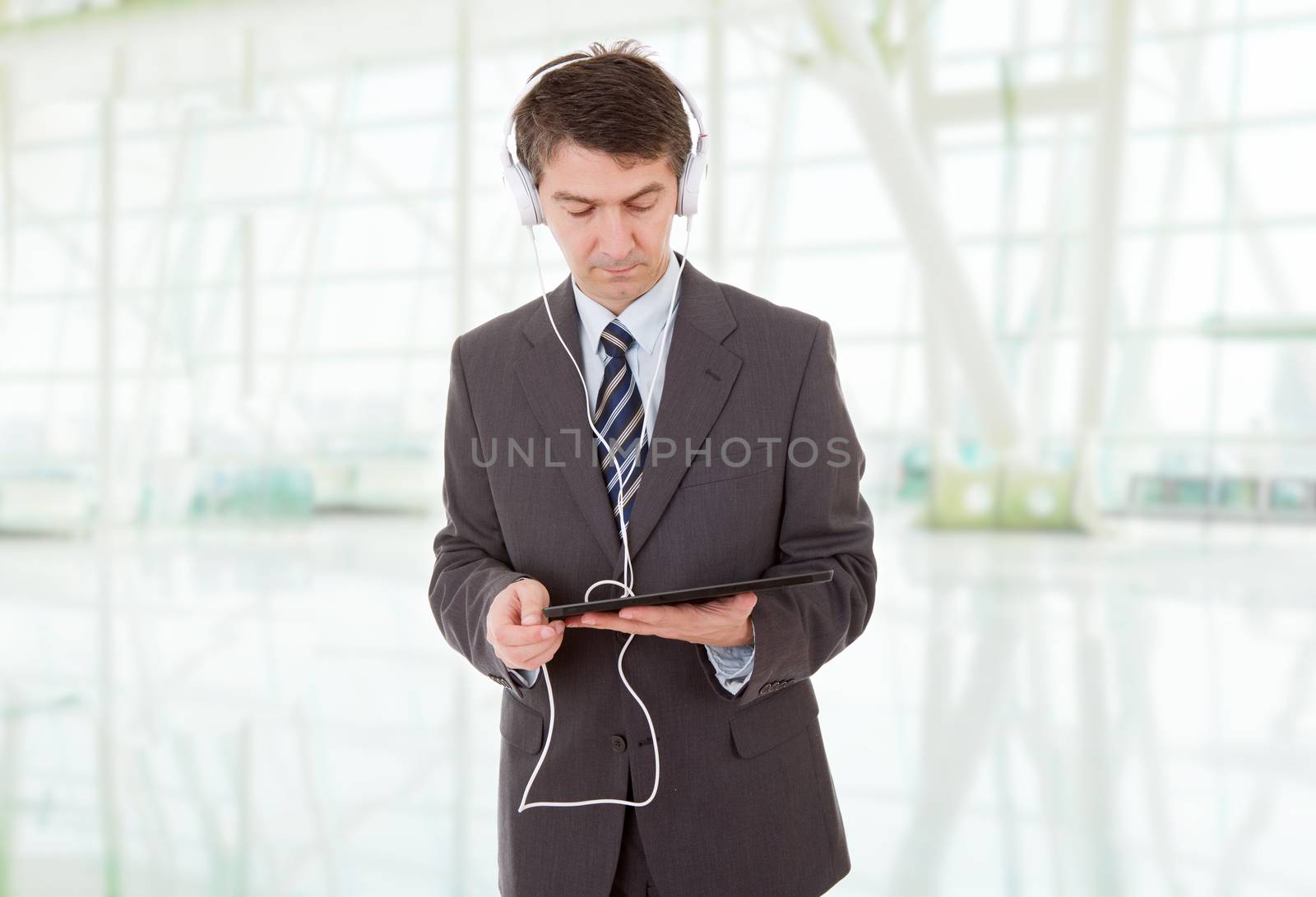 businessman with tablet pc and headphones, at the office