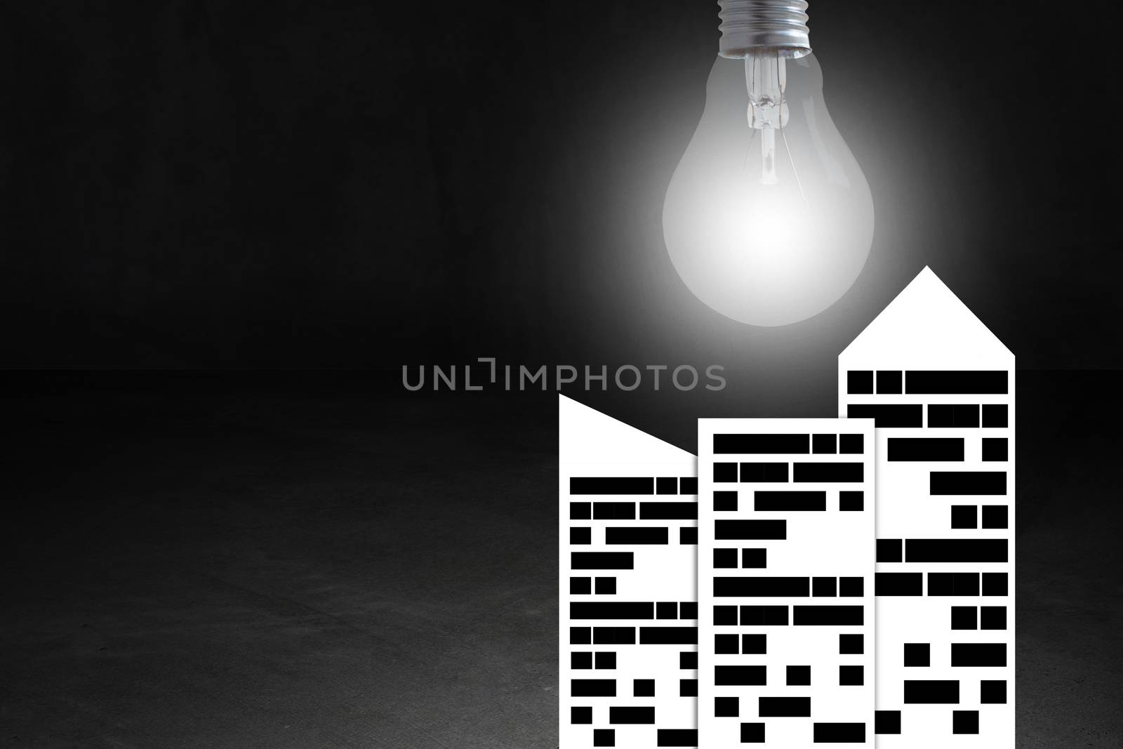 Energy concept, paper city and light bulb on dark background, nature and ecology