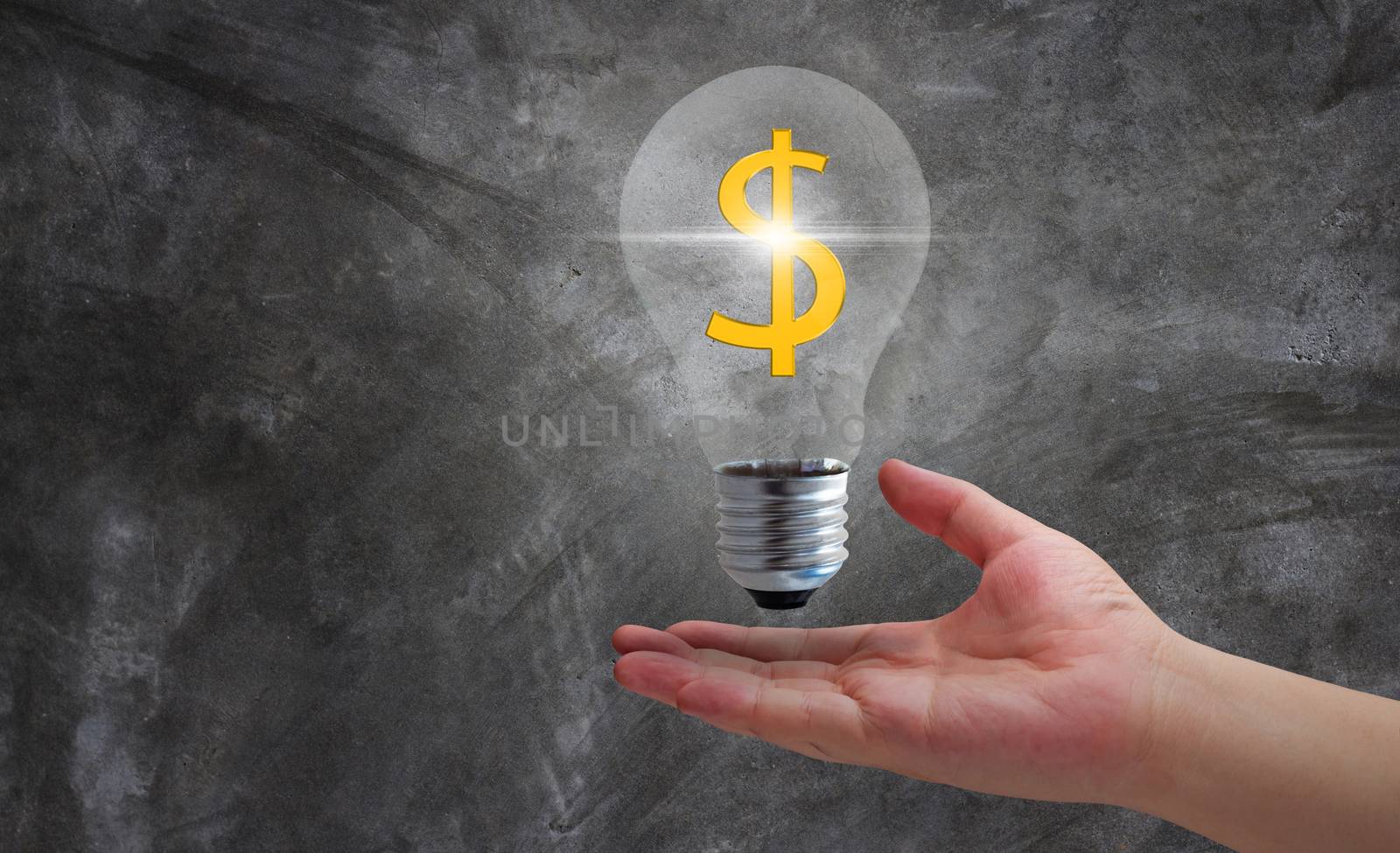 Money and energy concept, hand and light bulb on dark background, nature and ecology