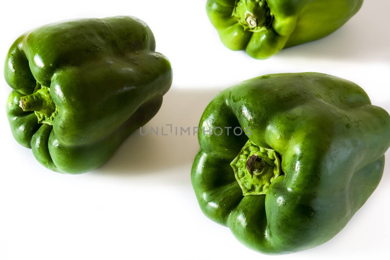 Fresh green peppers isolated on white background