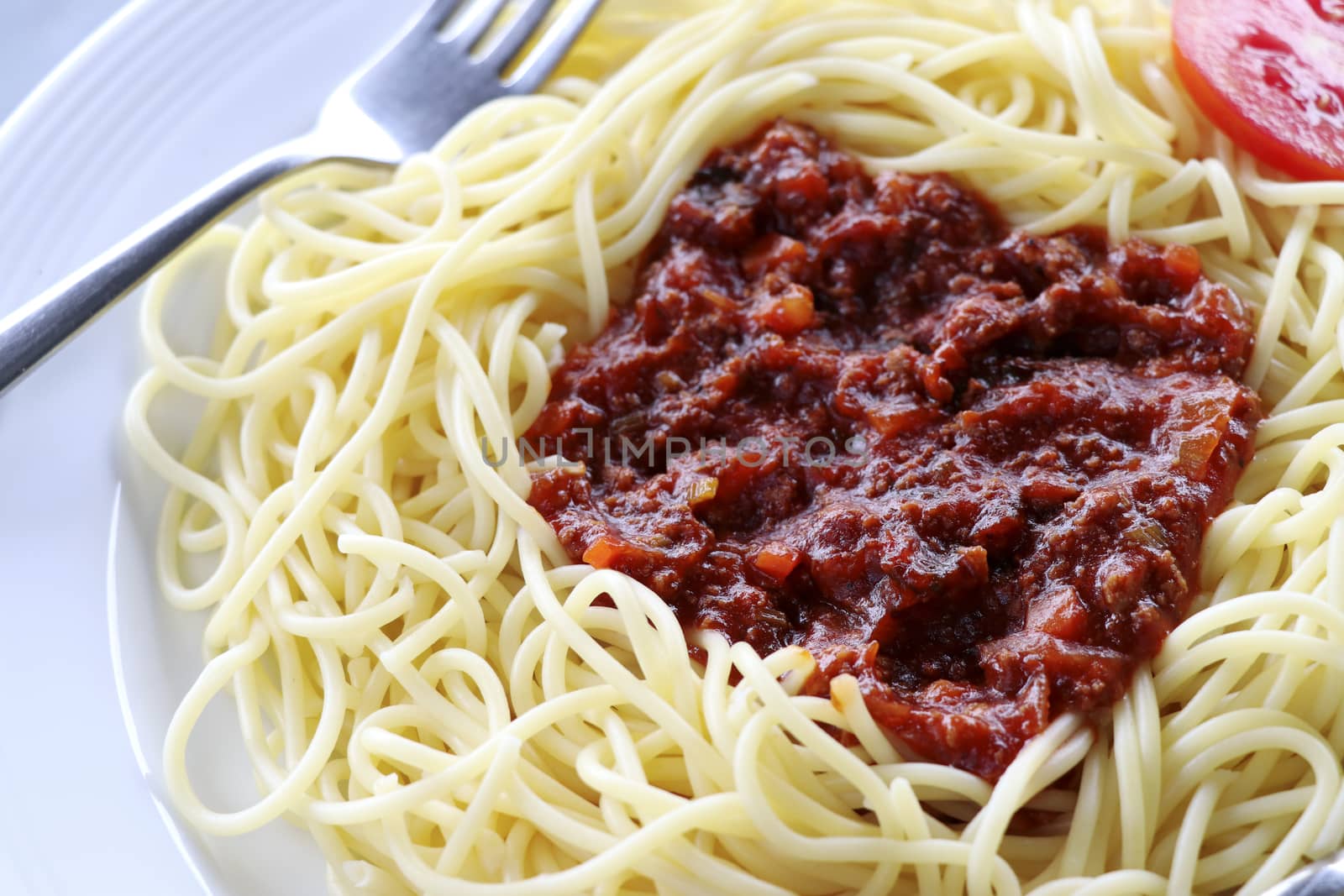 Spaghetti with tomato sauce and  minced meat. Spaghetti with tomato sauce on a white plate.