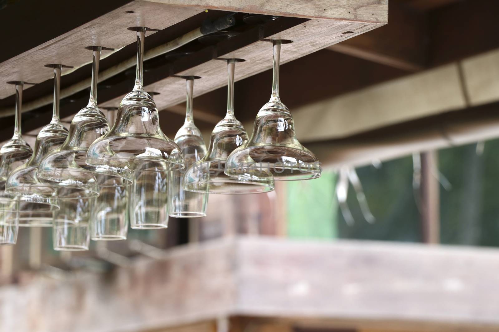 The drink glass was hung and stored with a glass hanger which is on the top of the bar.