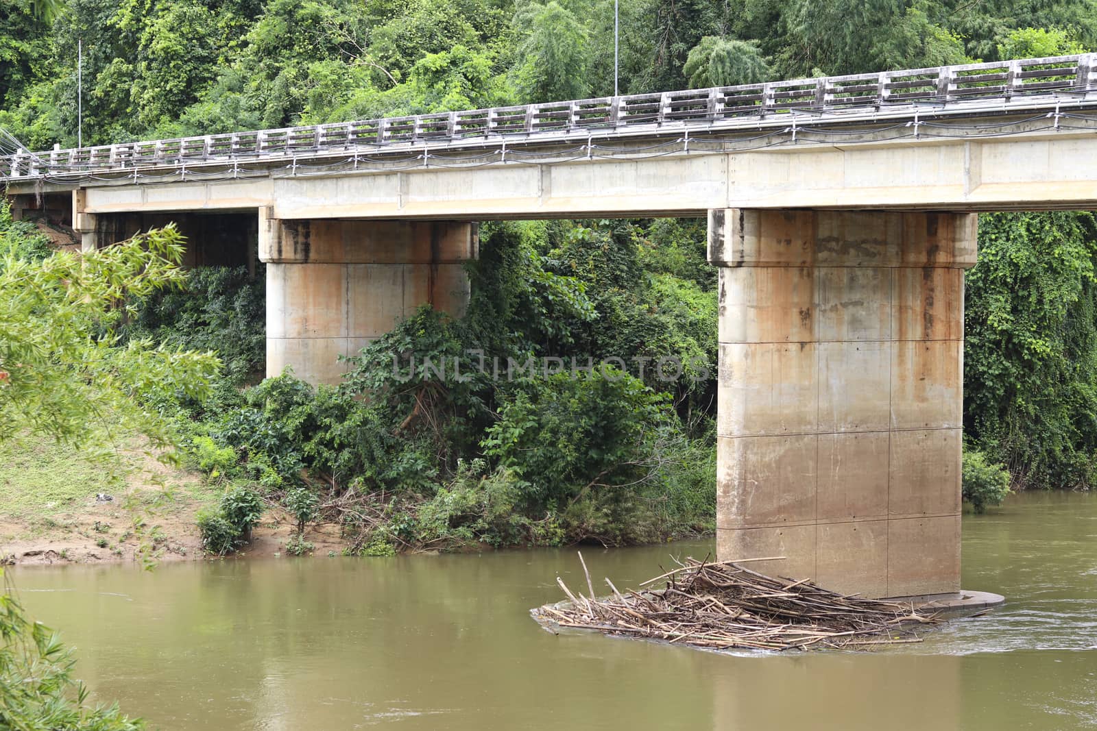 A bridge over the river that has wood chips at bunting bridge. by Eungsuwat