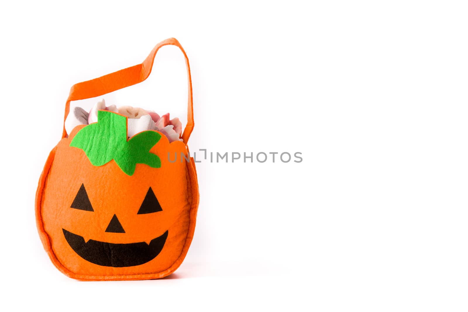 Halloween pumpkin bag with candies inside isolated on white background