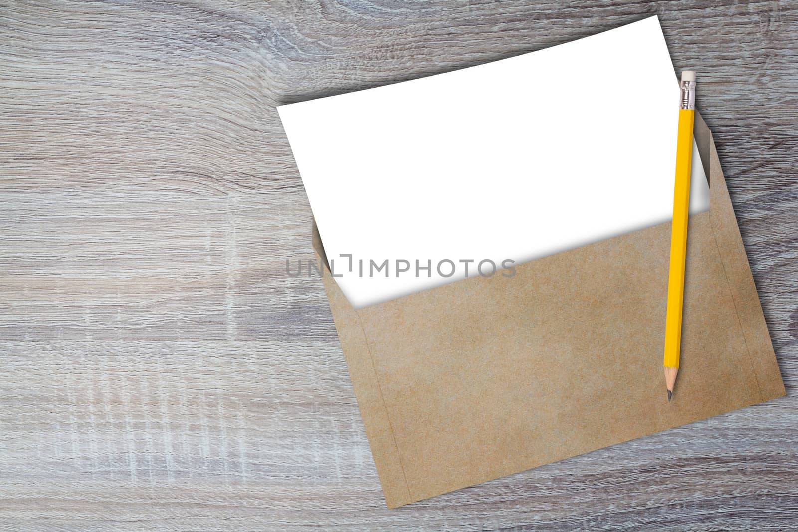 Opening business envelope, blank white paper and yellow pencil on wood background