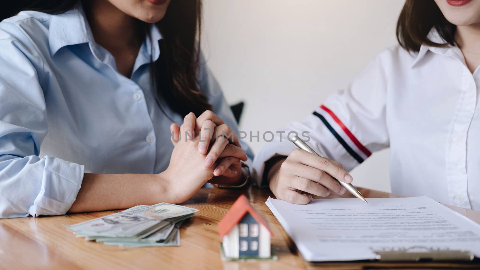 Real estate agent offer hand for customer sign agreement contract signature for buy or sell house. Real estate concept contact agreement concept
