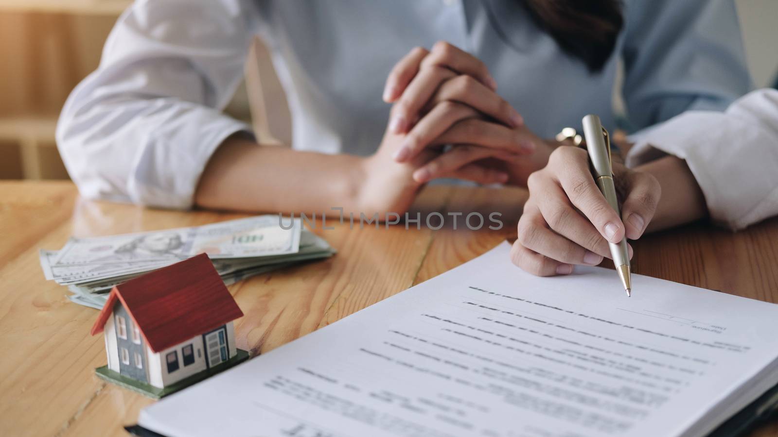 Real estate agent sign a contract documents agreement with custo by wichayada